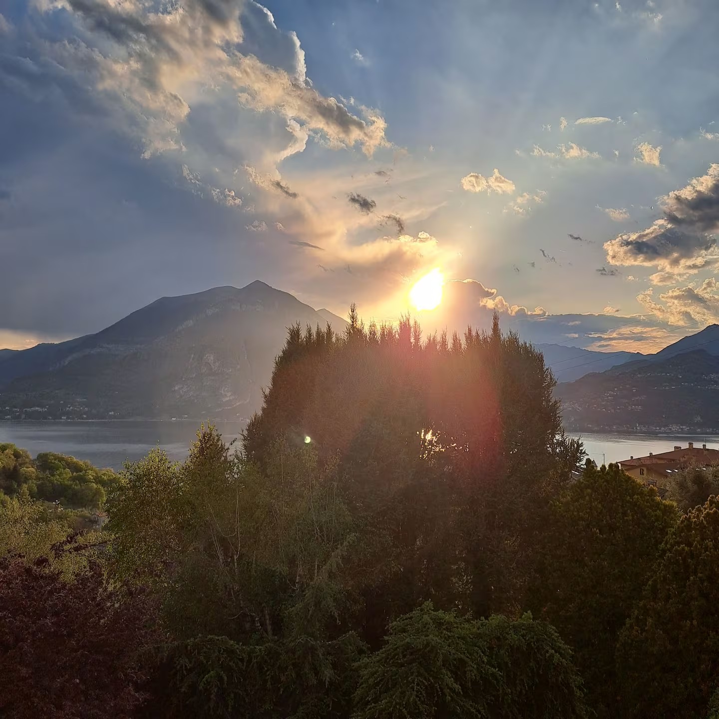 Sunset over Lake Como with sunbeams breaking through the clouds