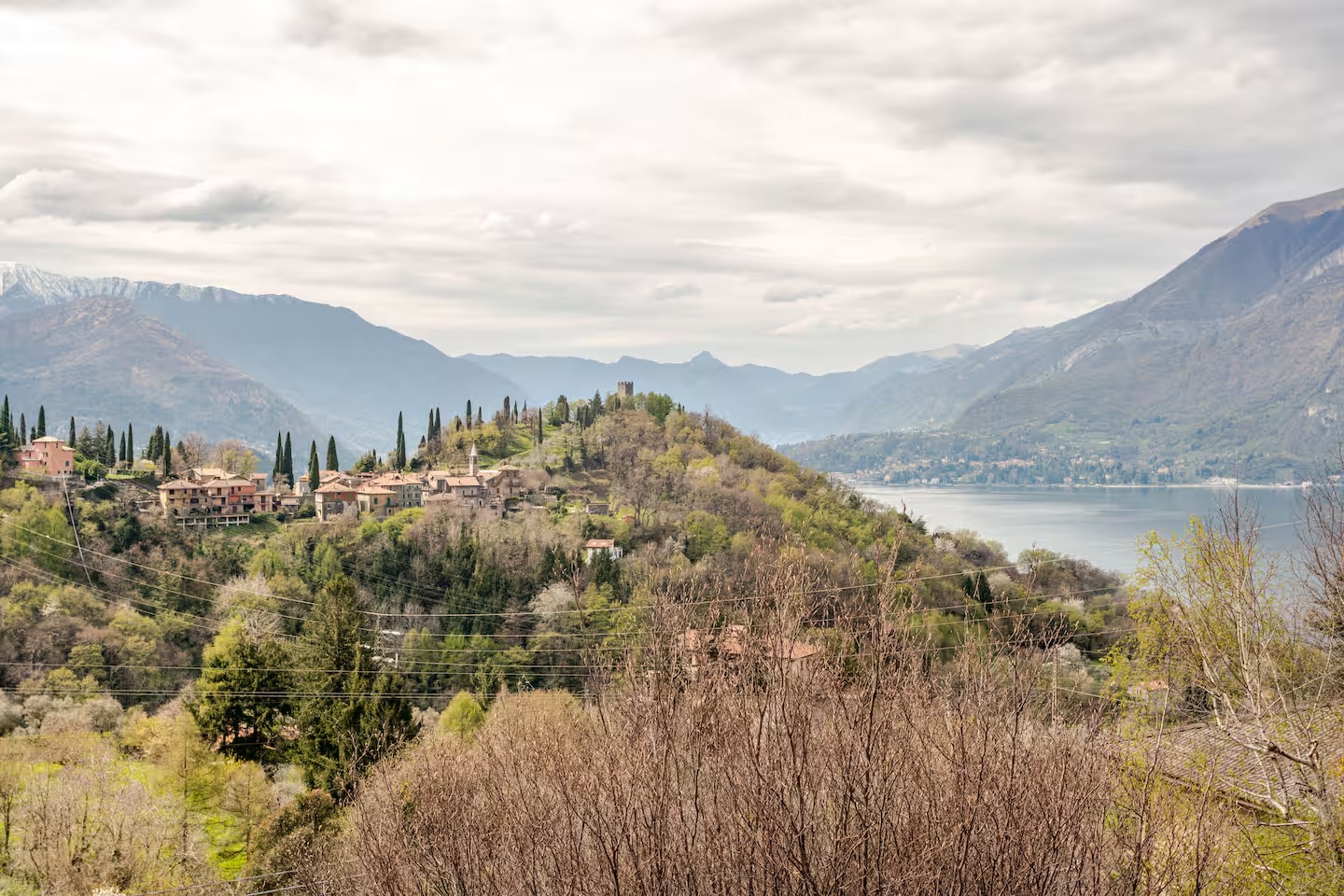 The hilltop village and castle tower above Lake Como seen from the house